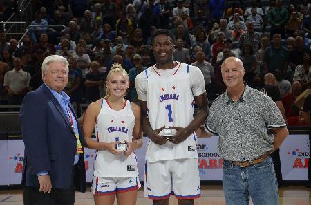 Indiana All-Star games director Mike Broughton (left) is with 2024 Miss Basketball Chloe Spreen of Bedford North Lawrence, 2024 Mr. Basketball Flory Bidunga of Kokomo and Brad Long of Jostens at the ring presentation ceremony during the 2024 Indiana-Kentucky All-Star doubleheader in Gainbridge Fieldhouse.