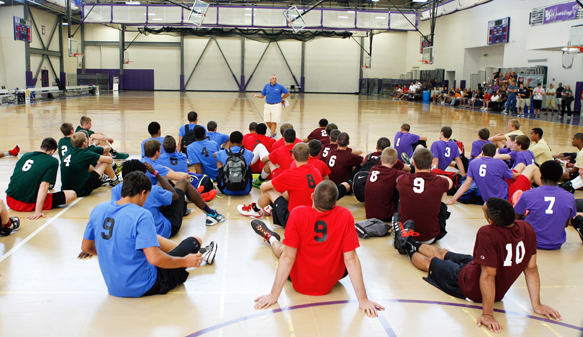 READY TO GO: Players at a past IBCA/IHSAA Boys Top 100 Underclass Showcase listen as former Top 100 on-court director Pete Smith (standing in blue shirt) provides instructions for the day.