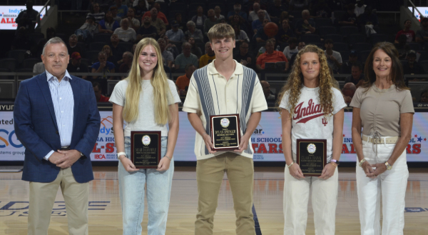AIKMAN HONOREES: Meah Dalrymple of North Daviess (second from left), Dylan Springer of Northridge (center) and Clara Hawk of Eastern Greene (second from right) are recognized as winners of the Pat Aikman Character and Leadership Award at the 2025 Indiana All-Star doubleheader in Gainbridge Fieldhouse. They are joined by Kurt Aikman (left) and Cindy Robinson (right), children of award namesake Pat Aikman.