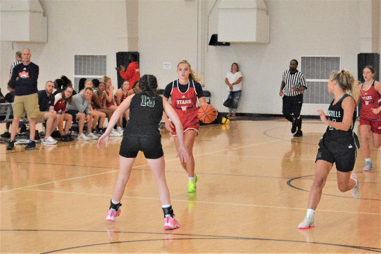 A Bedford North Lawrence player brings the ball up the court against Zionsville during the inaugural IBCA/IHSAA Girls' Team Showcase in 2023 at Mt. Vernon (Fortville). The Boys' Team Showcase and Girls' Team Showcase events are on the IBCA schedule again in June 2024
